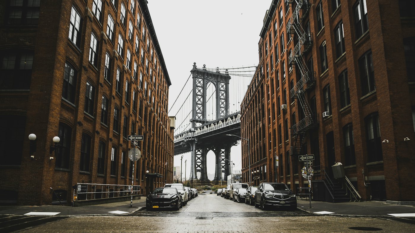 The Manhattan Bridge framed by red-brick buildings in DUMBO, Brooklyn